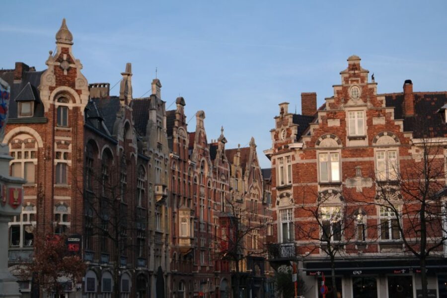 Ghent: Walking Tour from Friday Market to the Cathedral - The coach intro: Millionaires’ Quarter, stations, and style in the city